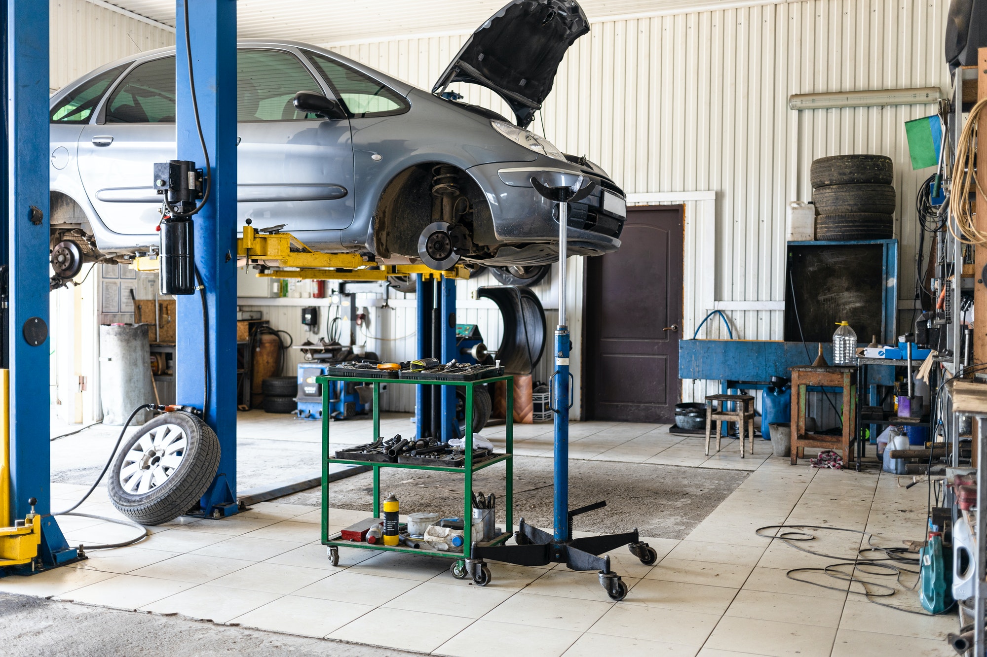 car-is-lifted-on-hydraulic-lift-in-car-workshop.jpg