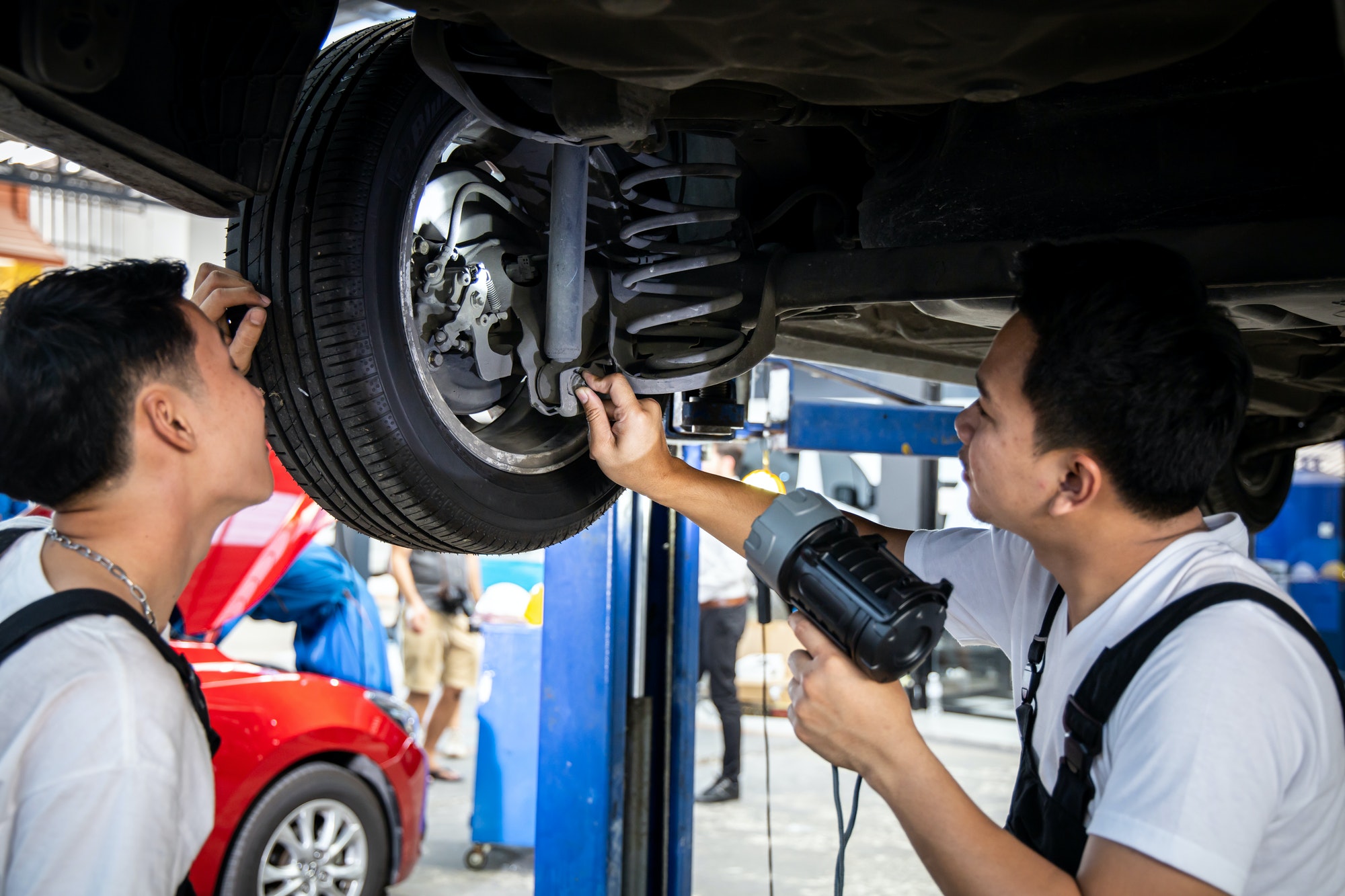 two-mechanic-was-checking-the-car-suspension-.jpg